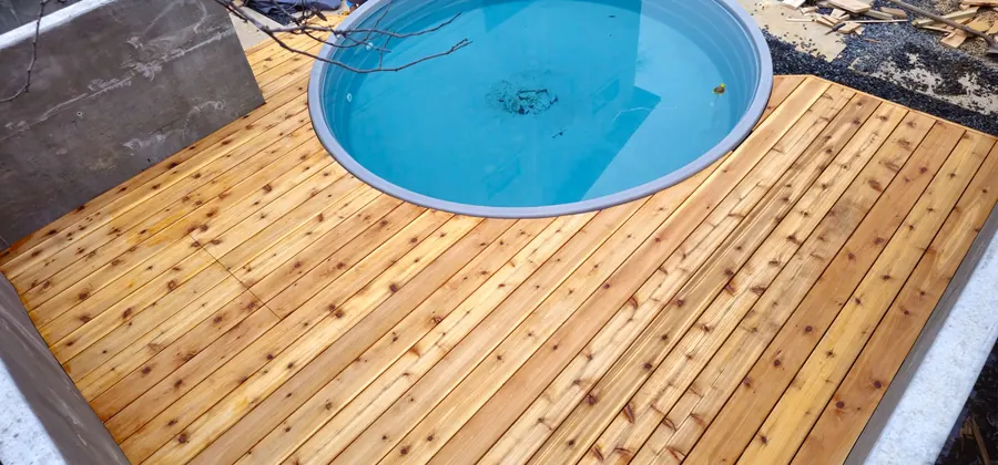 Custom cedar deck built around a stock tank pool