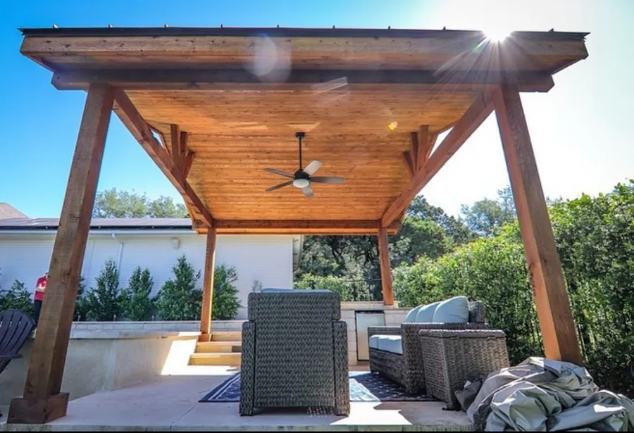 Cedar pavilion with tongue and groove ceiling and ceiling fan over an outdoor lounge area