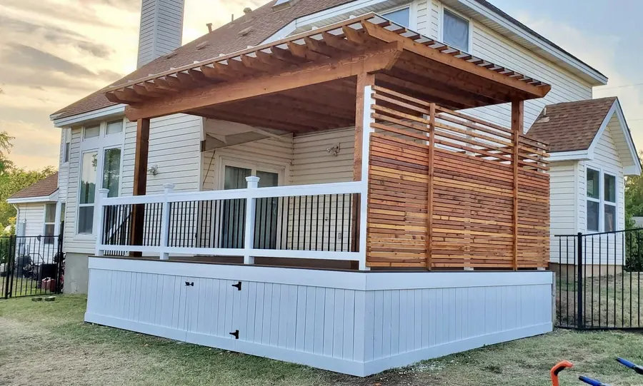 Cedar pergola built over a deck with white railing