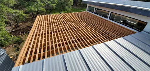Overhead view of a modern cedar pergola with 4-inch top slat spacing for more shade