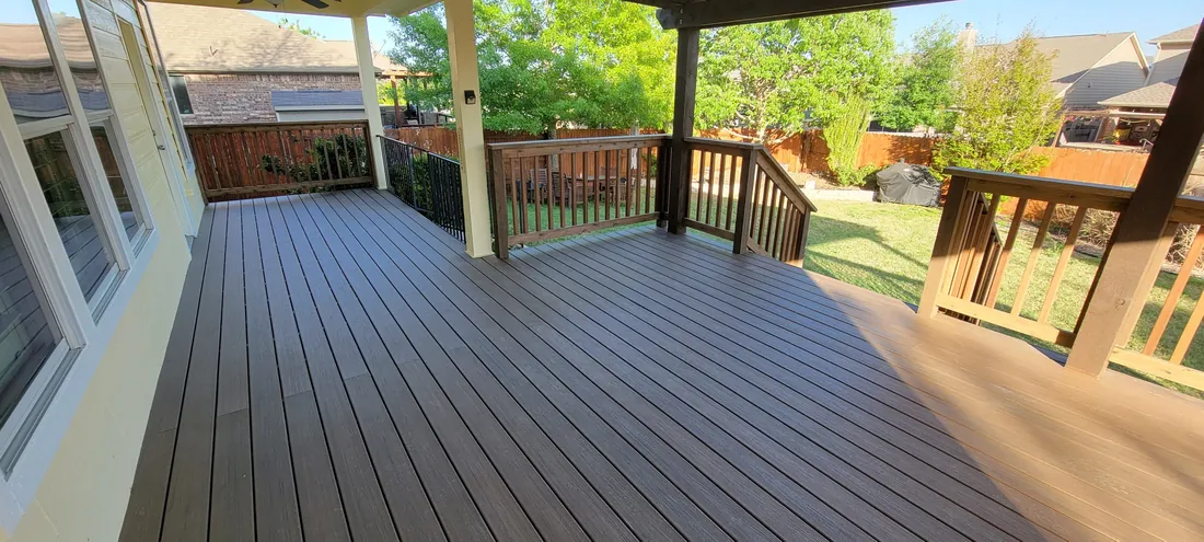 Composite deck with cedar railing stained to match