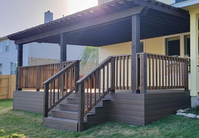 Composite deck with an attached pergola and stairs