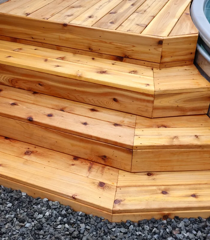 Angled custom deck steps built around a stock tank pool