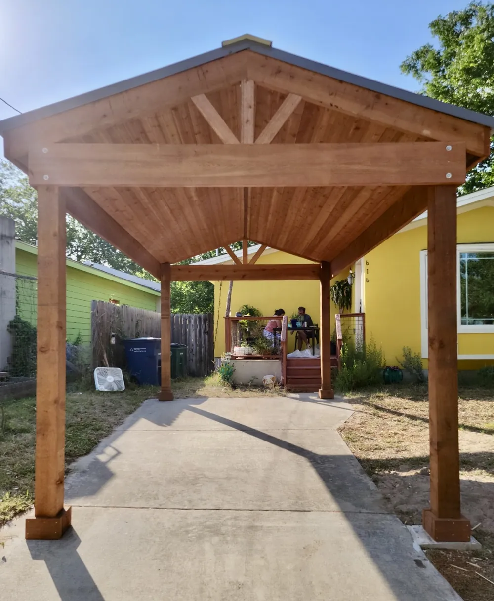 Freestanding one-car-wide gable carport with a finished cedar tongue and groove ceiling