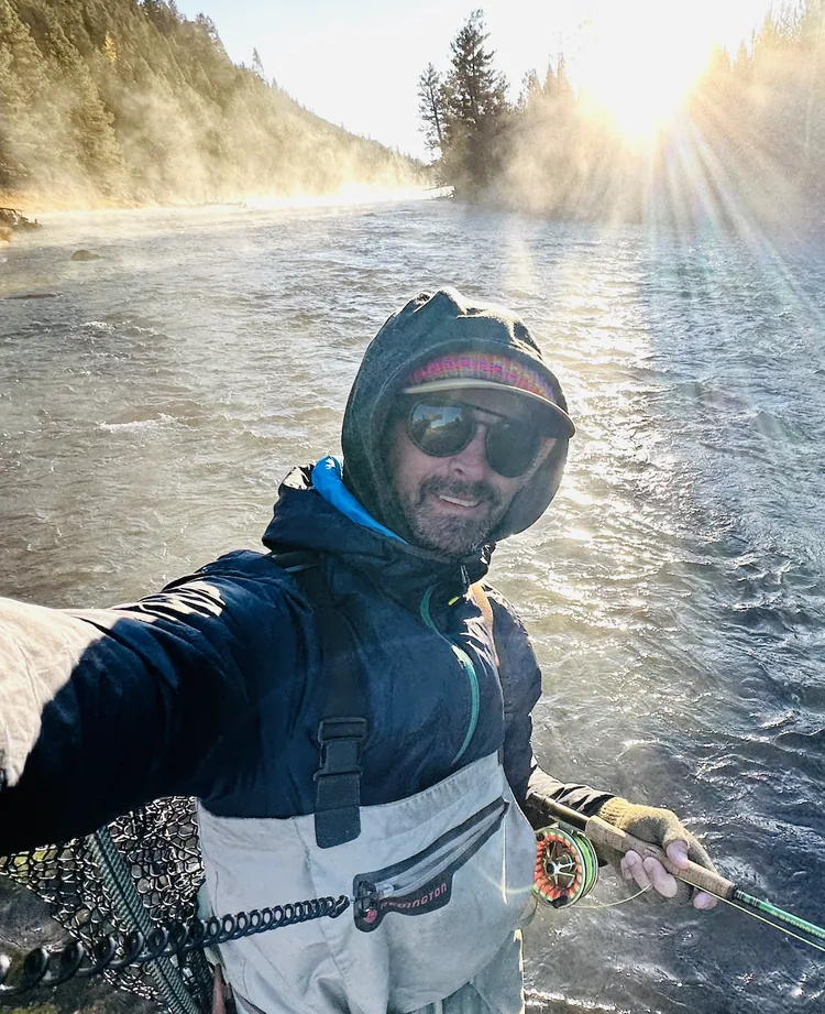 Justin Fitzpatrick, Owner and Sales Manager at Deck Giant, fly fishing in Colorado