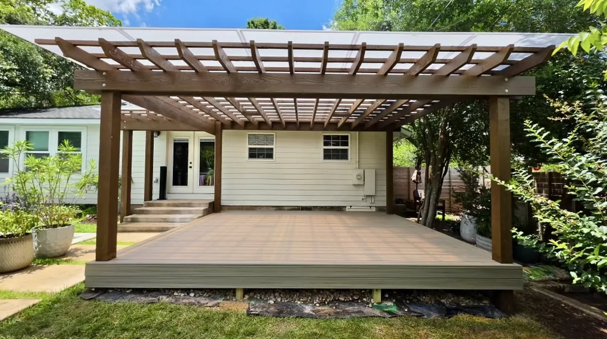 Modern attached pergola with a polycarbonate roof over a composite deck