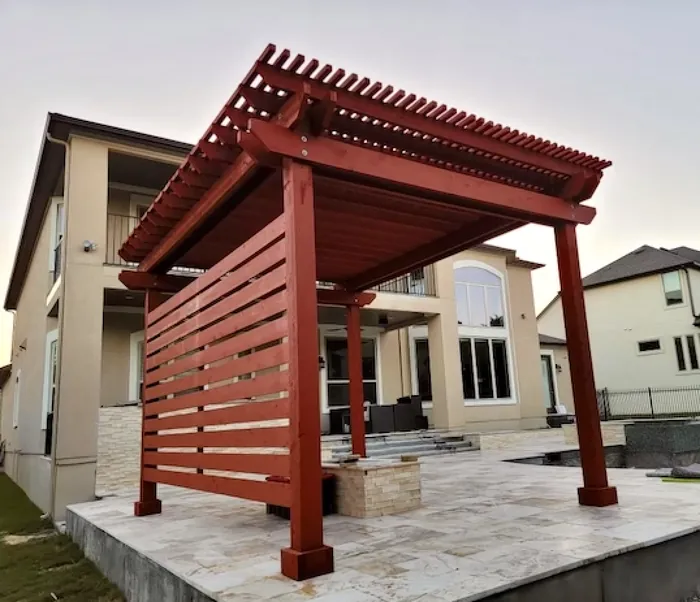 Red stained privacy wall on a pergola